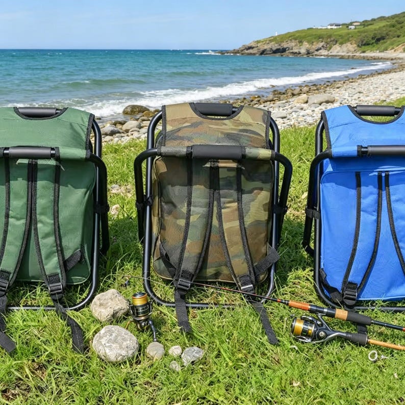 May include: Three portable folding chair backpacks in green, camouflage, and blue, each featuring a black metal frame and integrated shoulder straps. A fishing rod with a reel is positioned horizontally across the grass in front of the chairs.