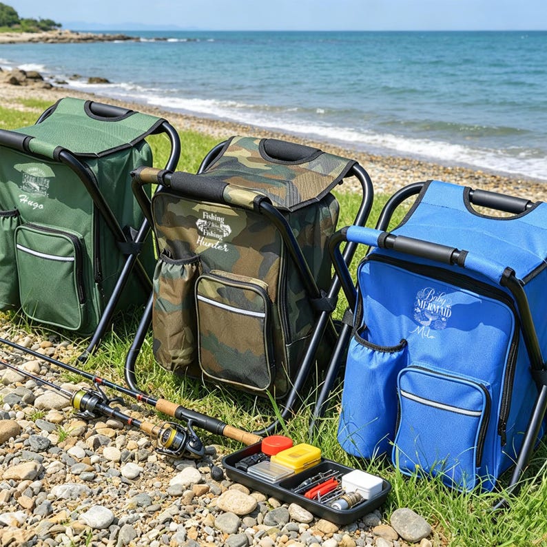 May include: Three portable folding chair backpacks in olive green, camouflage, and bright blue. Each features a front pocket, side pouch, and printed text including Hugo, Fishing Hunter, and Baby Mermaid. A black tackle tray and fishing rods lie nearby.