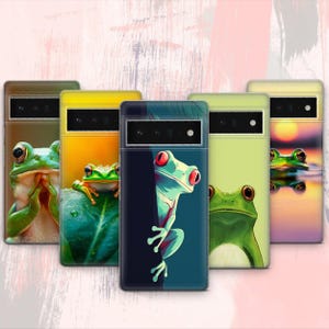 May include: Five different phone cases featuring frog designs. The cases are black, yellow, green, blue and purple. Each case has a unique frog design.