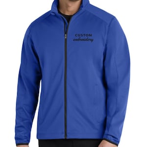 May include: Royal blue jacket with a black zipper and the words "CUSTOM embroidery" in black script. The jacket has a stand-up collar and two side pockets. The cuffs and hem are black.