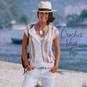 May include: A crochet vest top in shades of white, beige, and gray. The sleeveless top has a V-neck and is paired with white pants and a straw hat with a brown band. The text "Crochet Vest Top" is visible.