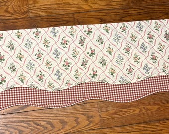 country-style farmhouse curtain valances featuring a floral patterned top layer and a red and white gingham checkered bottom layer.
