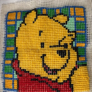 completed Winnie-the-Pooh latch hook craft 12x12”
