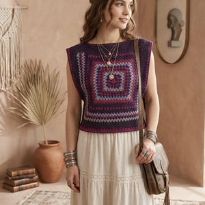 May include: A sleeveless crochet top in shades of purple, pink, and blue, paired with a cream-colored skirt. The top features a square pattern. The outfit is accessorized with layered necklaces, bracelets, and a brown leather bag.