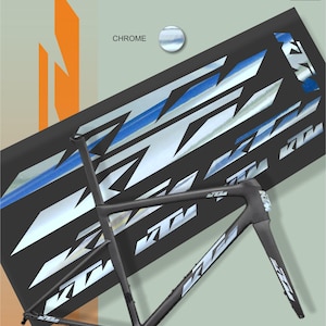 May include: A black KTM bicycle frame with chrome and white accents, set against a backdrop of a black graphic with the KTM logo. The image includes the text "CHROME" and "MAX MODEL STUDIO".