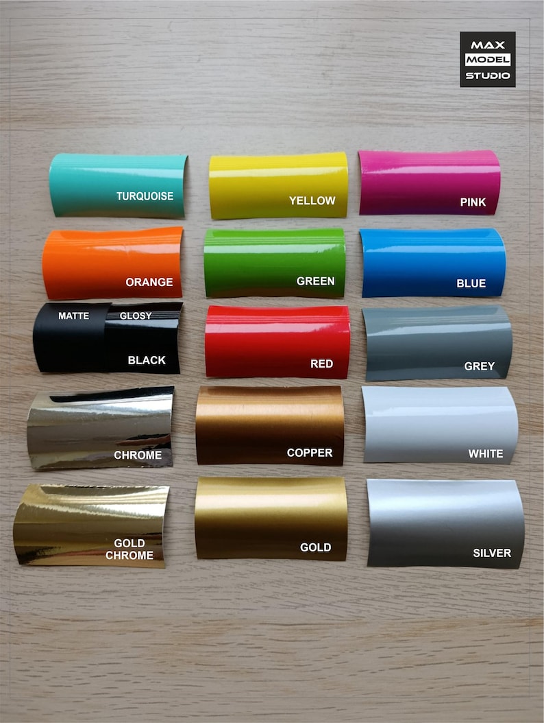 May include: A collection of colorful, curved metal samples, each labeled with a color name. Colors include turquoise, yellow, pink, orange, green, blue, black, red, grey, chrome, copper, white, gold chrome, gold, and silver.