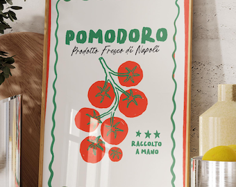 May include: A framed print with the word "POMODORO" in green, featuring a cluster of red tomatoes. The print has a white background with a green border and red accents. The text "Prodotto Fresco di Napoli" is also visible.