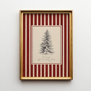 May include: Framed Christmas art print with a gold frame. The print features a sketched evergreen tree on a cream background, with the words "Oh Come Let Us Adore Him" below. The frame has a red and white striped pattern.