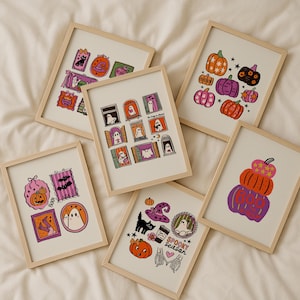 May include: A collection of framed Halloween-themed art prints. Each print features colorful illustrations of pumpkins, ghosts, bats, and other spooky elements. The prints are in light wood frames, perfect for seasonal decor.