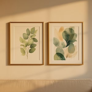 Puede incluir: Dos láminas botánicas enmarcadas. La lámina izquierda presenta una ilustración a la acuarela de una rama frondosa con hojas verdes y verde claro. La lámina derecha muestra un grupo de hojas estilizadas en tonos verdes y beige.