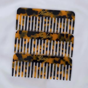 May include: Three tortoiseshell combs with gold lettering. The top comb says "Katie", the middle comb says "Taylor", and the bottom comb says "Ying".
