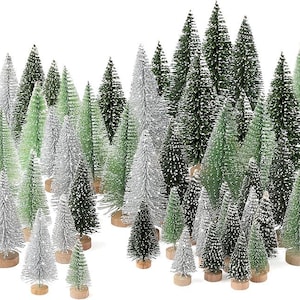 Puede incluir: Una colección de árboles de Navidad en miniatura en varios tonos de verde y plata, algunos con un toque blanco. Los árboles están dispuestos muy juntos, creando una apariencia de bosque. Cada árbol está montado sobre una pequeña base de madera redonda.