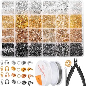 May include: A clear plastic organizer filled with various jewelry-making supplies. Includes clasps, jump rings, crimp beads, and other findings in silver, gold, and black. Also shown are spools of clear and silver beading wire, pliers, and tweezers.