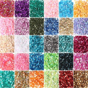 May include: Assortment of 36 colors of round iridescent sequins. The sequins are arranged in a grid pattern.