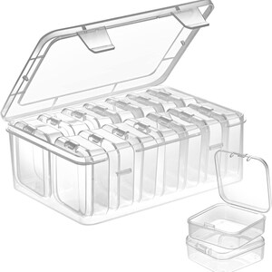 May include: A clear plastic organizer with a hinged lid, divided into multiple compartments. The lid is open, revealing the interior sections. Two smaller, individual clear containers are also shown.