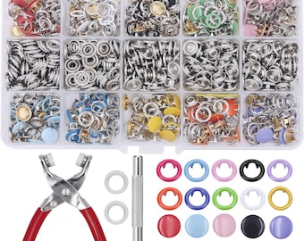 May include: A set of assorted snap fasteners in various colors and sizes, including silver, gold, black, white, red, blue, green, and yellow. The set also includes a tool for attaching the snaps, a set of rings, and a set of buttons.