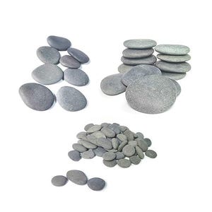 May include: A collection of smooth, gray river rocks of various sizes. Some are stacked, others are in piles, and some are scattered. The stones have a natural, weathered appearance, perfect for decorative use or crafts.