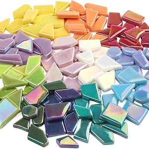 May include: A collection of iridescent mosaic tiles in a rainbow of colors. The tiles are various shapes, including triangles, squares, and irregular forms. Colors range from yellow to purple and blue.