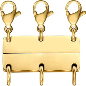 May include: Gold-toned metal chain extender with three lobster claw clasps. The extender has a rectangular bar with three loops.