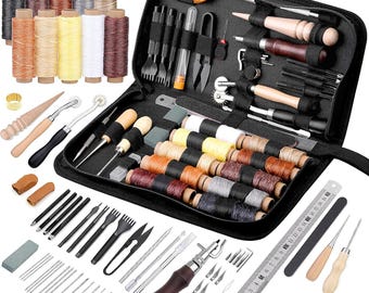 May include: A black leather sewing kit containing a range of tools, including needles, thread, awls, and a hammer. The kit also features a selection of coloured threads and a ruler.