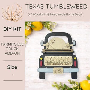 May include: A farmhouse truck add-on DIY wood kit with the text "LEMONADE" and "Hello". The truck is black, with light blue, red, and yellow accents. The kit includes a wooden lemon shape and floral details.