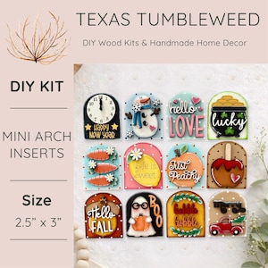 May include: A collection of mini arch inserts, each measuring 2.5" x 3", with various designs. The designs include a clock, snowman, the words "hello LOVE", a pot of gold, carrots, a lemon, a peach, an apple, the words "Hello FALL", a ghost, and a truck.