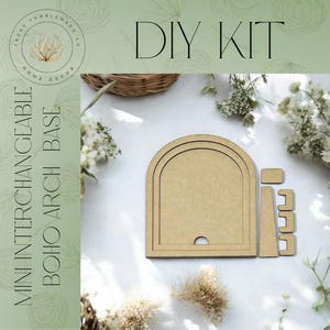 May include: DIY kit for a miniature interchangeable boho arch base. The kit includes a wooden arch with three layers, a small wooden rectangle, and two smaller wooden rectangles. The arch is a light brown color.