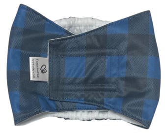 May include: A blue and black plaid pet belly wrap with a white interior. The wrap has a hook and loop closure and a tag with the Etsy shop name and website.