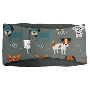 May include: A gray dog-themed headband with a fleece lining. The headband features a repeating pattern of cartoon dogs in various colors and styles, along with white heart outlines. The text "Fuzzy Friends" is visible on a small tag.