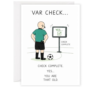 May include: A greeting card featuring a cartoon referee in a green shirt and black shorts looking at a monitor displaying 'YES...' with a checkmark. The text reads 'VAR CHECK...', 'CHECK COMPLETE', and 'CHECK COMPLETE. YES... YOU ARE THAT OLD.'