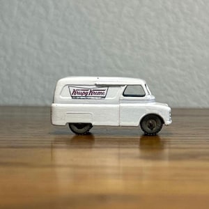 May include: White toy van with a "Krispy Kreme" logo on the side.
