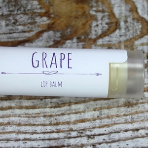 May include: A white tube of lip balm with a purple label that says "GRAPE LIP BALM".