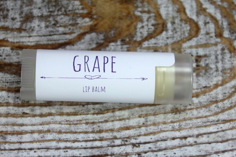 May include: A white tube of lip balm with a purple label that says "GRAPE LIP BALM".