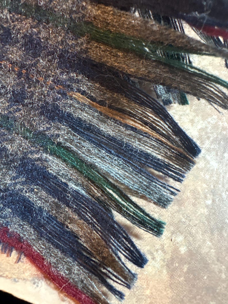 May include: A white ceramic mug with a black handle and the text "But First, Coffee" in a black, handwritten-style font. The mug is on a white surface.