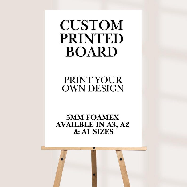 May include: A white custom printed board on a wooden easel. The board features the text "CUSTOM PRINTED BOARD" and "PRINT YOUR OWN DESIGN". It is available in A3, A2, and A1 sizes, made of 5mm Foamex.