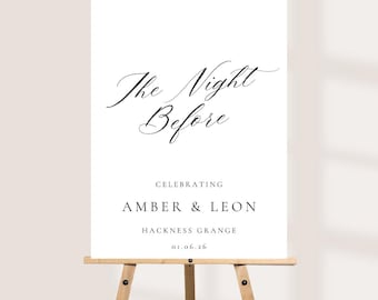 May include: A white rectangular sign on a wooden easel featuring black text that reads The Night Before, CELEBRATING AMBER & LEON, HACKNESS GRANGE, and 01.06.26. The top line is in a flowing script font, while the remaining text is in a serif font.