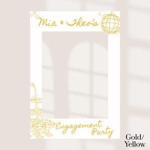 May include: White photo booth prop with gold text and illustrations. The text reads "Mia & Theo's" and "Engagement Party." A disco ball and champagne glasses are also featured. The prop is designed for engagement parties.