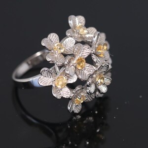 Silver ring in the shape of flowers