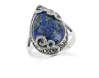 May include: A silver ring featuring a large, teardrop-shaped stone with a blue and green marbled pattern. The stone is surrounded by a decorative silver setting with small, dark accents. The ring has a split shank design.