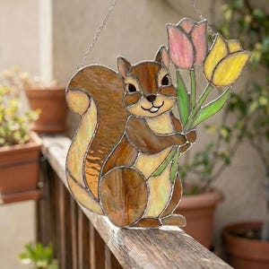 May include: A white ceramic mug with a black handle and the text "But First, Coffee" in a black, bold font. The mug is on a white surface.