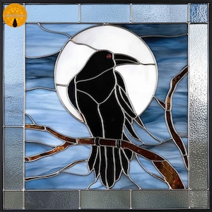 May include: Stained glass panel featuring a black raven perched on a branch against a blue sky and a full moon. The raven has a red eye and is set within a black frame. The artwork is a decorative piece.