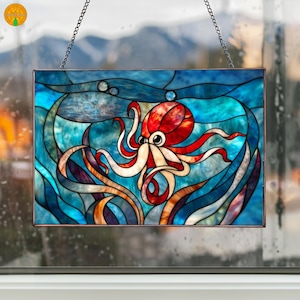 May include: Stained glass panel featuring an octopus in shades of red, white, and blue. The octopus is surrounded by blue water and orange and brown seaweed. The panel is rectangular and hangs from a chain.