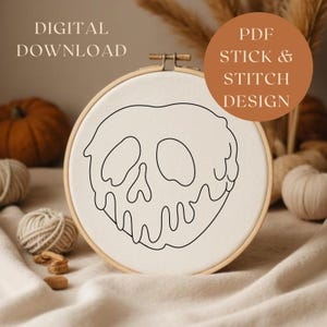 Puede incluir: Un bastidor de bordado con un dise&ntilde;o de calavera en negro sobre tela crema. El texto "DIGITAL DOWNLOAD" est&aacute; en la parte superior izquierda, y "PDF STICK & STITCH DESIGN" en un c&iacute;rculo a la derecha.
