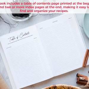 May include: An open recipe book with a table of contents page and lined pages. The text reads "Table of Contents" and "Stay Organized and Find Your Favorite Recipes Easily." Cinnamon sticks, apples, and nuts surround the book.