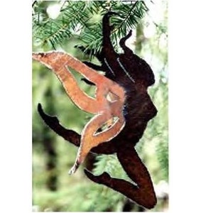 May include: A metal fairy silhouette with wings, in a rusty brown color, hanging from a tree branch.