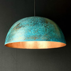 May include: A teal blue and copper dome pendant light fixture with a hammered metal finish.