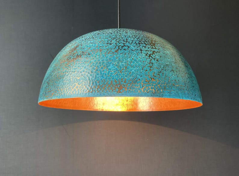 May include: A teal blue and copper dome-shaped pendant light fixture with a hammered metal finish.