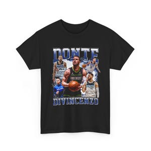 May include: Black t-shirt featuring a graphic of basketball player Donte DiVincenzo in a Timberwolves uniform, with the name "DONTE DIVINCENZO" in blue and white text. The design includes images of the player in action.