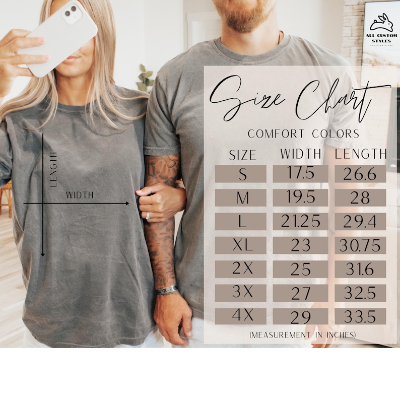 May include: A size chart for Comfort Colors t-shirts is displayed, showing measurements in inches. The chart includes sizes S through 4X, with width and length dimensions provided for each size. The image also shows two people wearing gray t-shirts.