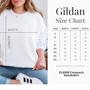 May include: A white Gildan crewneck sweatshirt with a size chart. The chart shows measurements in inches for sizes S to 5XL, including width, length, and sleeve length. The text "G18000 Crewneck Sweatshirt" is also visible.